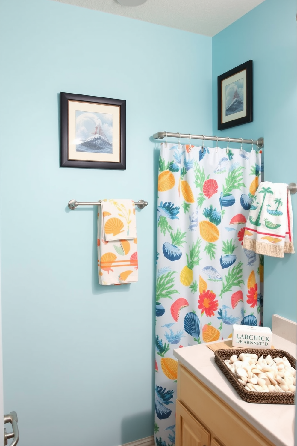 A bright and cheerful bathroom adorned with playful beach-themed prints. The walls feature light blue paint, complemented by framed artwork depicting seashells and ocean waves. A stylish shower curtain showcases vibrant tropical patterns, while matching towels hang neatly on a rack. The vanity is decorated with a small potted plant and a decorative tray filled with seashells for a coastal touch.