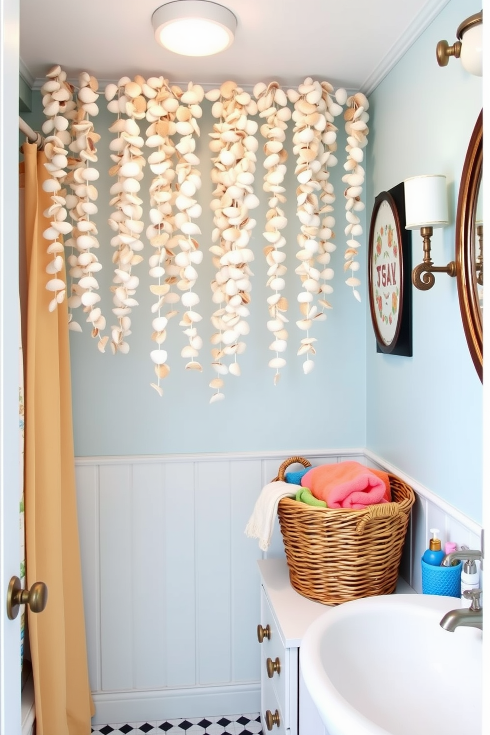 A charming summer bathroom decorated with seashell garlands hanging from the ceiling. The walls are painted in a soft ocean blue, and a wicker basket filled with colorful towels sits in the corner.