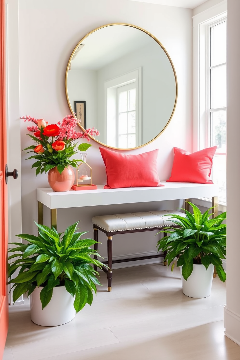 A bright and inviting summer entryway features a sleek console table adorned with coral accents. A large round mirror with a thin gold frame hangs above the table, reflecting natural light from the nearby window. Vibrant coral throw pillows are placed on a stylish bench, inviting guests to sit and remove their shoes. Potted plants with lush green foliage flank the doorway, adding a fresh and lively touch to the space.