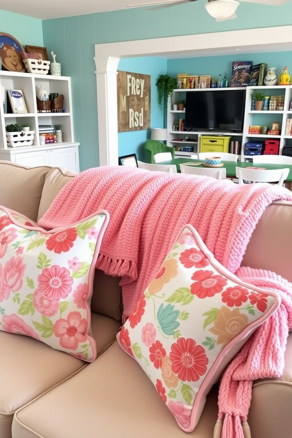 A cozy summer-themed living space featuring throw pillows with vibrant floral patterns and soft, textured blankets in pastel colors. The arrangement creates a welcoming atmosphere, perfect for relaxation and enjoying the warm weather. A lively game room designed for summer fun with bright wall colors and playful decor elements. The space includes a large table for board games, comfortable seating, and shelves filled with summer-themed games and activities.