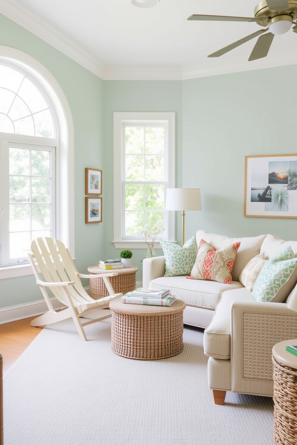 A bright and airy summer living room features a vintage beach chair positioned near a large window that allows natural light to flood the space. The walls are painted in a soft seafoam green, and a light-colored area rug anchors the seating area, complemented by a cozy sectional sofa adorned with colorful throw pillows.