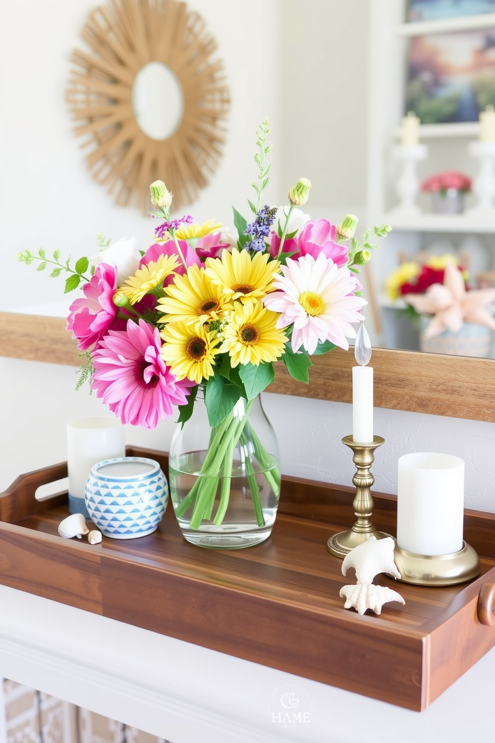 Create a bright and airy summer mantel display using a wooden tray as the central organizing piece. Arrange vibrant seasonal flowers in a vase on the tray alongside decorative candles and a few carefully placed seashells for a coastal touch.