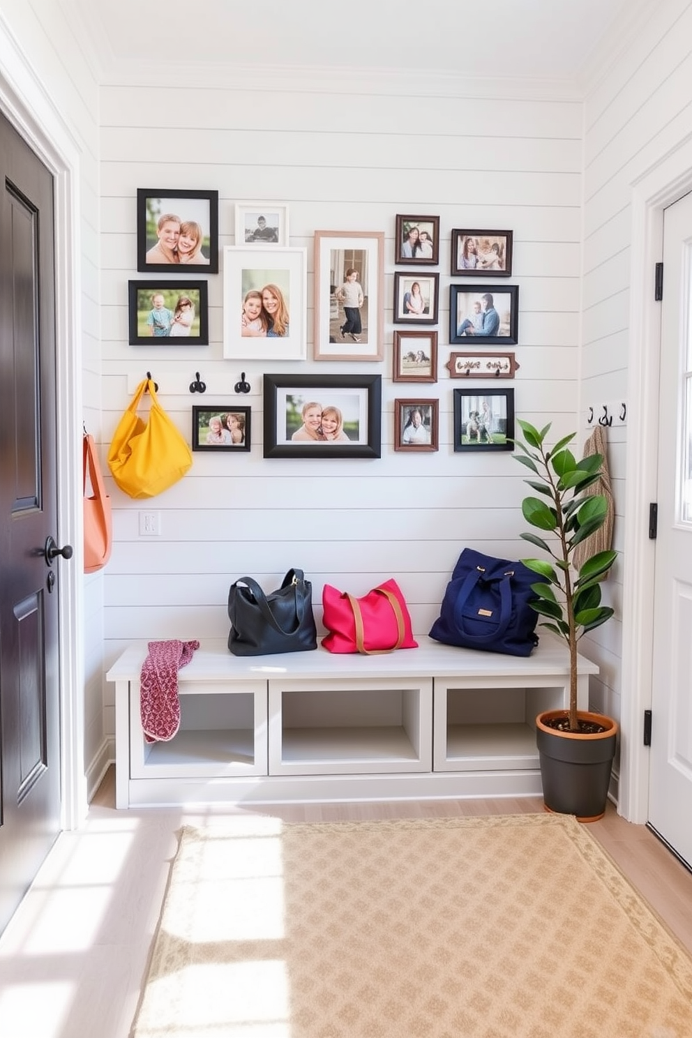 A bright and airy mudroom features a built-in bench with storage underneath, surrounded by light gray shiplap walls. A gallery wall of family photos in various frames hangs above the bench, showcasing cherished memories and adding a personal touch to the space. The floor is covered with a durable, patterned rug that complements the color scheme. Decorative hooks line the wall, holding colorful bags and jackets, while a potted plant sits in the corner, bringing a touch of nature indoors.