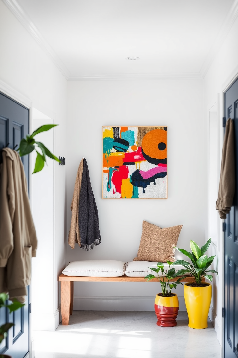 A bright and airy mudroom filled with natural light. The walls are painted in a soft white, and a colorful abstract artwork hangs prominently, adding a vibrant touch to the space. A wooden bench with plush cushions sits against one wall, surrounded by hooks for hanging coats and bags. Potted plants in cheerful ceramic pots add a fresh and lively atmosphere to the room.