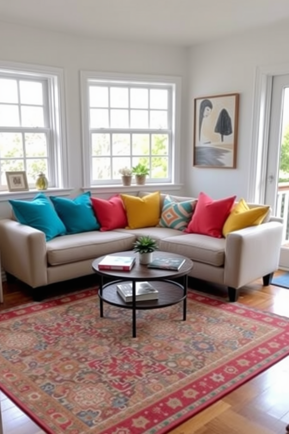 A cozy living room filled with natural light. A small sofa is adorned with throw pillows in vibrant colors like turquoise, coral, and sunshine yellow, creating a cheerful atmosphere. A round coffee table sits in the center, topped with a few art books and a small potted plant. The walls are painted a soft white, and a colorful area rug anchors the space, adding warmth and texture.