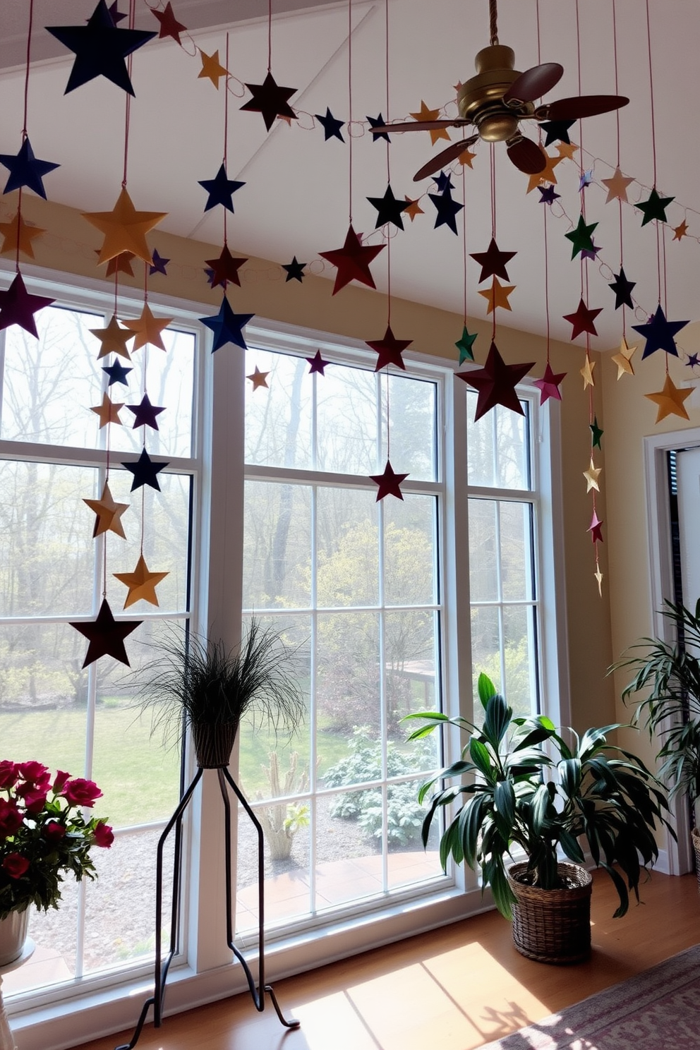 A cozy sunroom adorned with hanging garlands of colorful paper stars. Soft natural light filters through large windows, creating a warm and inviting atmosphere for Hanukkah celebrations.