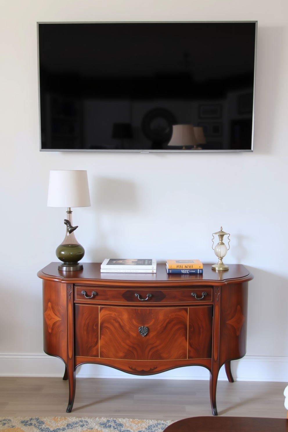 A stylish media console is positioned against the wall, featuring a sleek design with a combination of wood and metal finishes. Above the console, a large flat-screen TV is mounted, surrounded by decorative accents such as framed artwork and elegant vases. The living room is designed with a cozy seating arrangement, including a plush sofa and accent chairs that invite relaxation. Soft lighting from stylish lamps enhances the ambiance, creating a warm and inviting atmosphere perfect for entertaining guests.