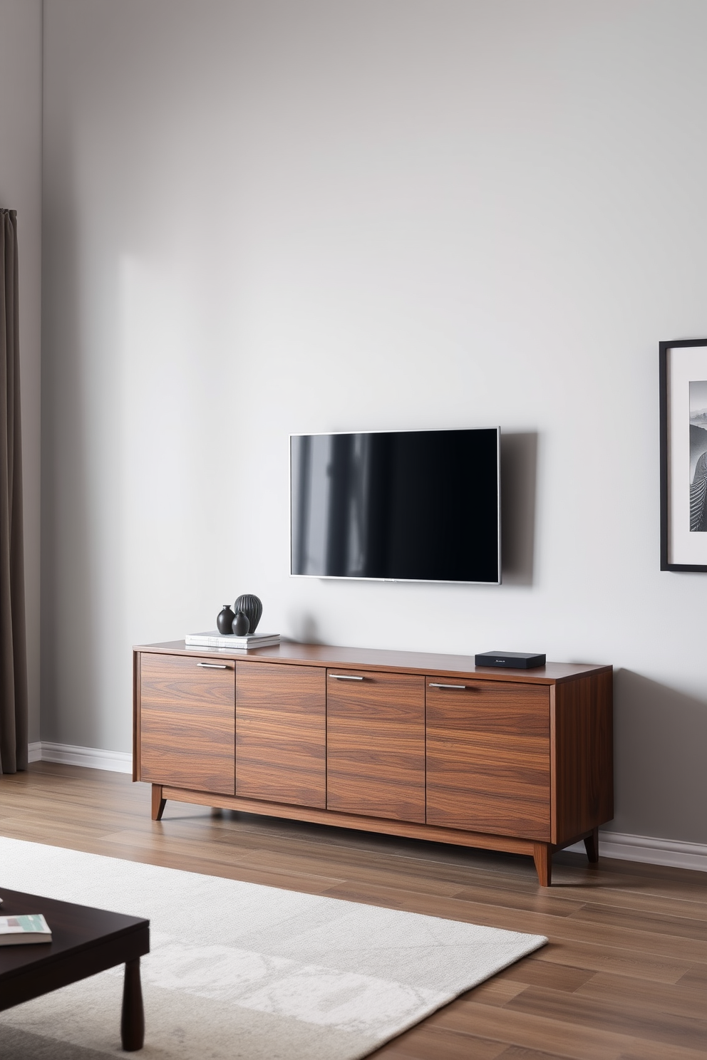 A modern living room featuring a sleek TV mounted above a stylish credenza. The credenza is finished in a rich walnut wood with clean lines, and the wall behind it is painted in a soft gray to create a cozy atmosphere.