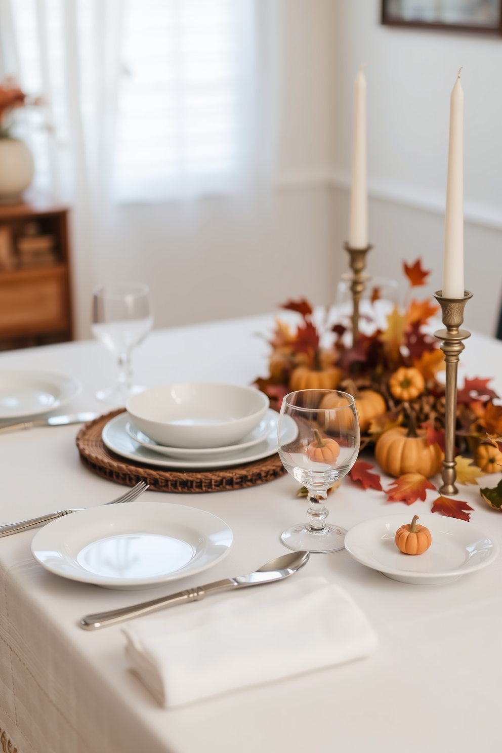 A beautifully set dining table featuring simple white dishes arranged elegantly on a crisp white tablecloth. The table is adorned with seasonal decorations such as small pumpkins and autumn leaves, creating a warm and inviting atmosphere for Thanksgiving.