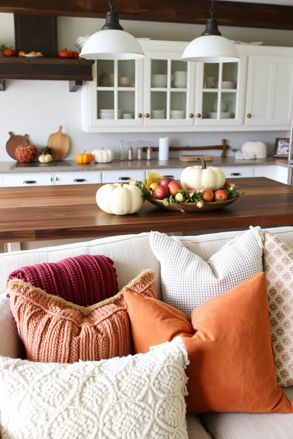 A cozy Thanksgiving kitchen setting featuring layered textures and an array of throw pillows. The kitchen island is adorned with a rich wooden surface, complemented by soft, textured pillows in warm autumn colors scattered across the seating area.