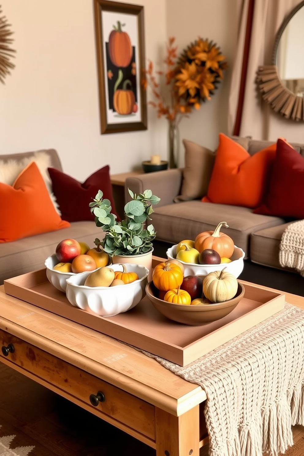 A cozy small living room adorned for Thanksgiving features a stylish coffee table topped with decorative bowls filled with seasonal fruits like apples, pears, and pumpkins. The warm color palette includes rich oranges and deep reds, complemented by plush throw pillows and a soft knitted blanket draped over a comfortable sofa.