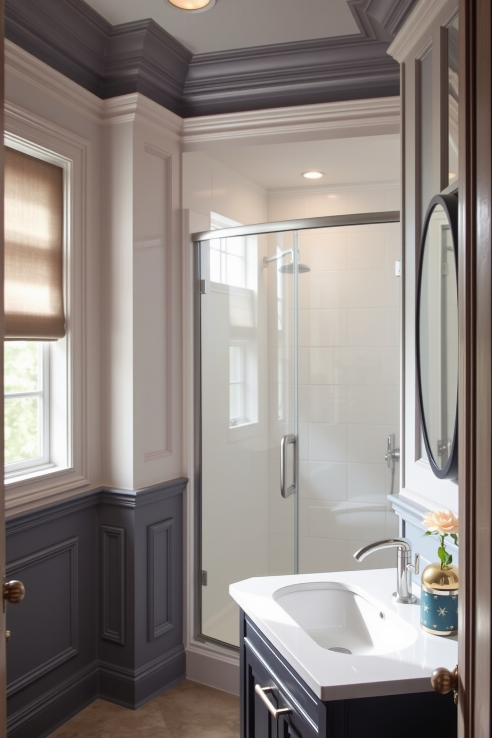 A stylish three-quarter bathroom featuring elegant architectural details. The walls are adorned with subtle accent colors that enhance the molding and trim, creating a sophisticated atmosphere. The shower area is enclosed with glass panels, allowing natural light to flow in. A sleek vanity with a modern sink complements the overall design, while decorative elements bring warmth and personality to the space.