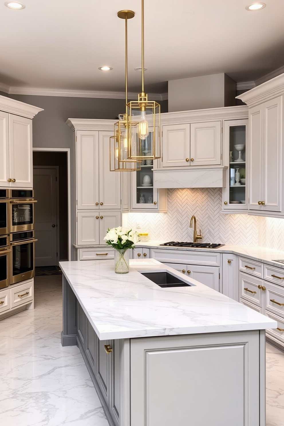 A luxurious kitchen featuring marble countertops that combine elegance with durability. The cabinetry is a classic white with brushed gold hardware, and the backsplash is a stunning herringbone pattern in soft gray tones. The kitchen island is large and inviting, topped with a beautiful slab of marble that serves as both a workspace and a gathering spot. Pendant lights with a modern design hang above the island, casting a warm glow over the space.