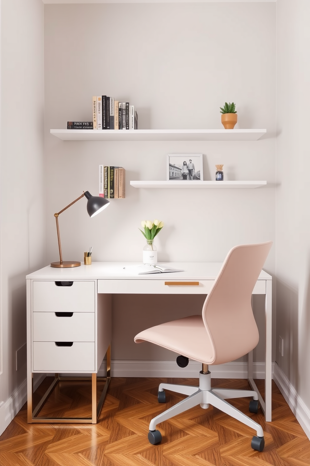 A stylish small workspace designed for a tiny apartment. The desk is a sleek white finish with gold accents, paired with a comfortable ergonomic chair in a soft pastel color. On the wall above the desk, there are floating shelves displaying books and decorative items. The space is illuminated by a modern pendant light, and a small potted plant adds a touch of greenery.