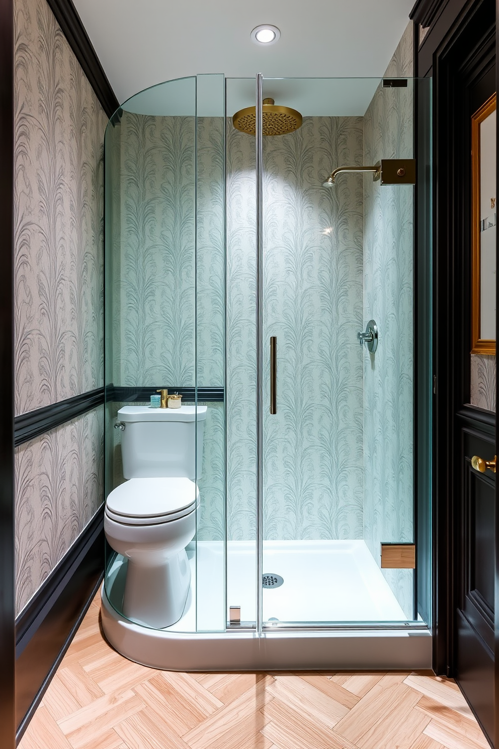 A tiny powder room with a sleek glass shower door that creates an open and airy feel. The walls are adorned with elegant wallpaper, and the floor features a chic herringbone pattern in light wood tones.