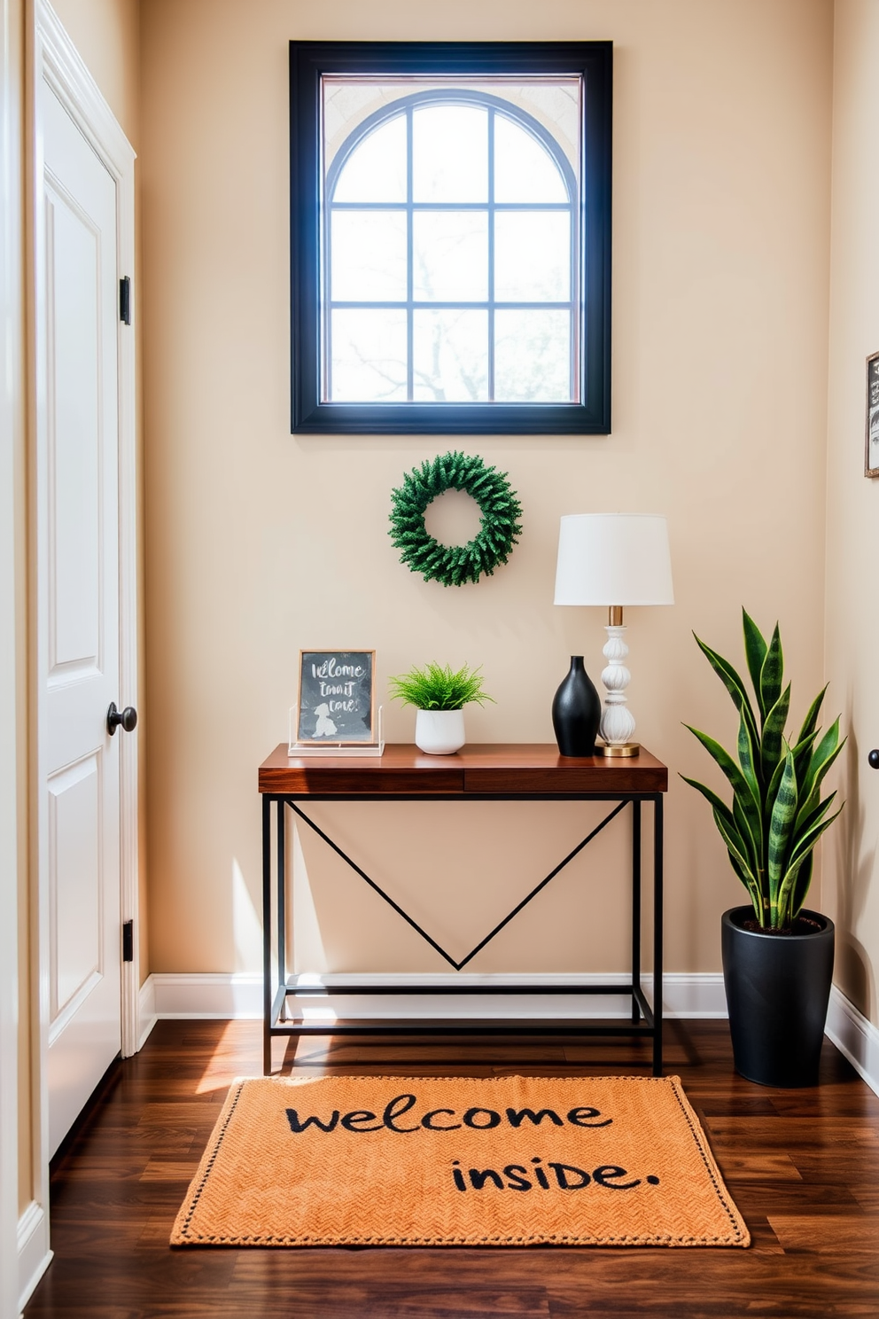 A cozy townhouse entryway features a welcoming mat with a fun message that invites guests inside. The walls are painted in a soft beige, complemented by a stylish console table adorned with decorative items and a small potted plant.