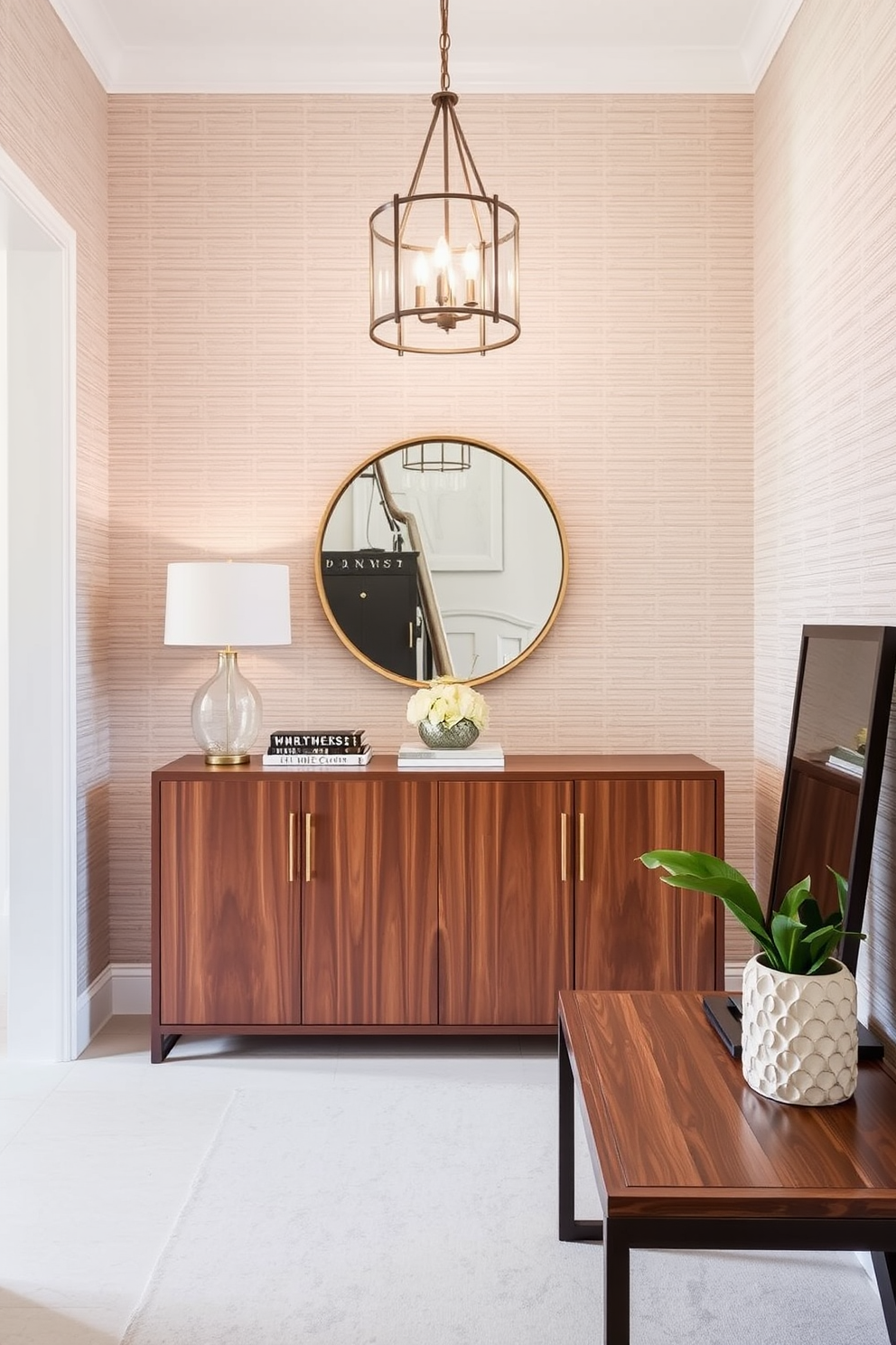 Textured wallpaper adds a layer of depth and sophistication to the townhouse entryway. The walls are adorned with a subtle geometric pattern that complements the warm wood tones of the console table and the elegant lighting fixture above.