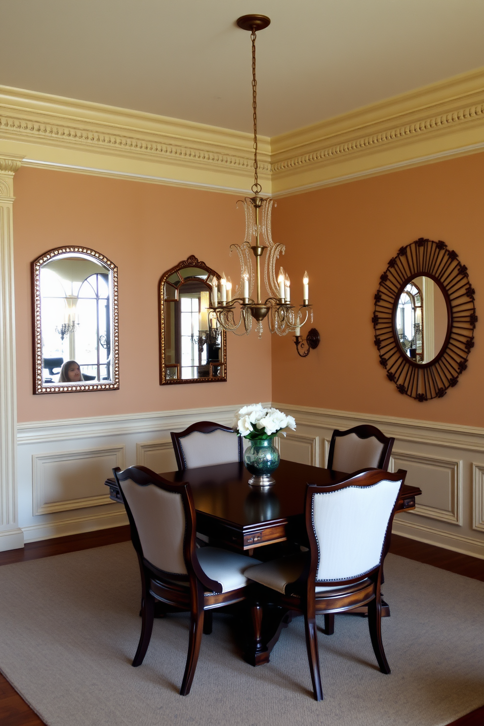 A traditional dining room featuring decorative mirrors that reflect natural light and create an inviting atmosphere. The room has a classic wooden dining table surrounded by upholstered chairs, with elegant chandeliers hanging above. The walls are adorned with soft, warm colors, complemented by intricate moldings and wainscoting. A large decorative mirror is placed on one wall, enhancing the sense of space and brightness in the room.