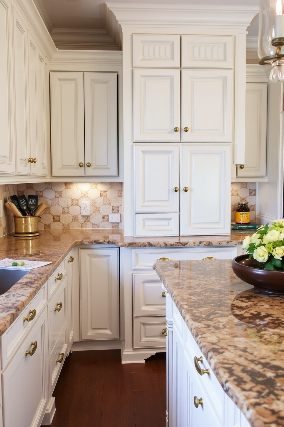 A traditional kitchen featuring granite countertops with rich textures that add depth and warmth to the space. The cabinets are painted in a classic white finish, complemented by antique brass hardware for an elegant touch.