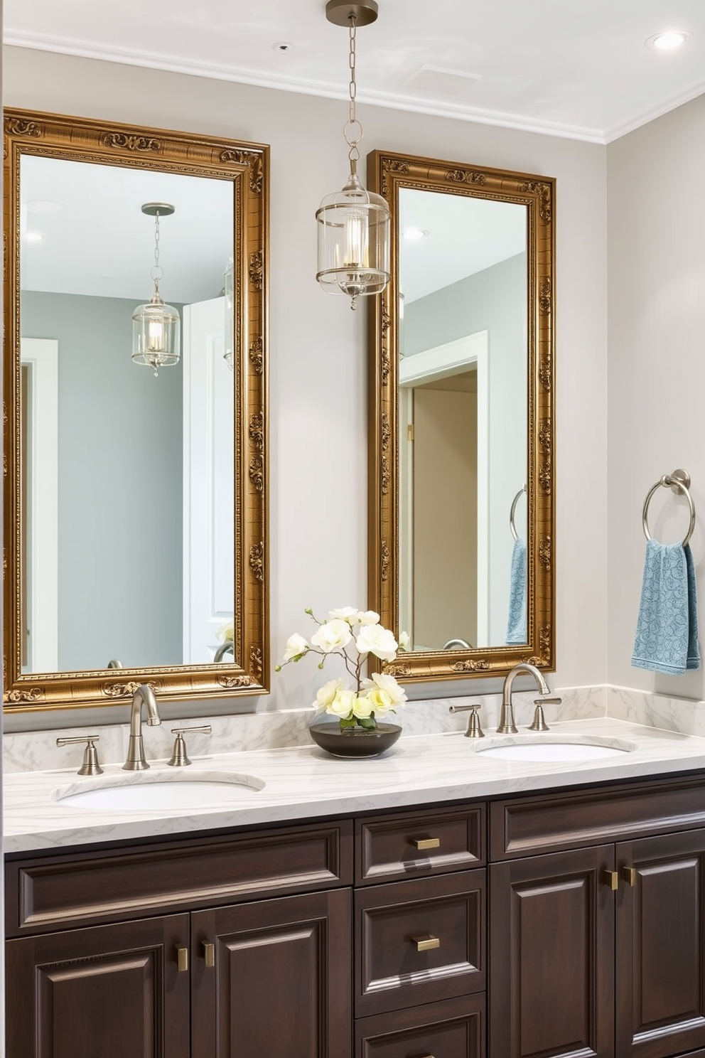 A transitional bathroom design featuring framed mirrors that enhance the elegance of the space. The mirrors are adorned with intricate detailing and are positioned above a sleek double vanity with a polished stone countertop. The color palette includes soft neutrals with pops of muted blue, creating a serene atmosphere. Stylish light fixtures hang above the vanity, illuminating the space while complementing the overall design theme.