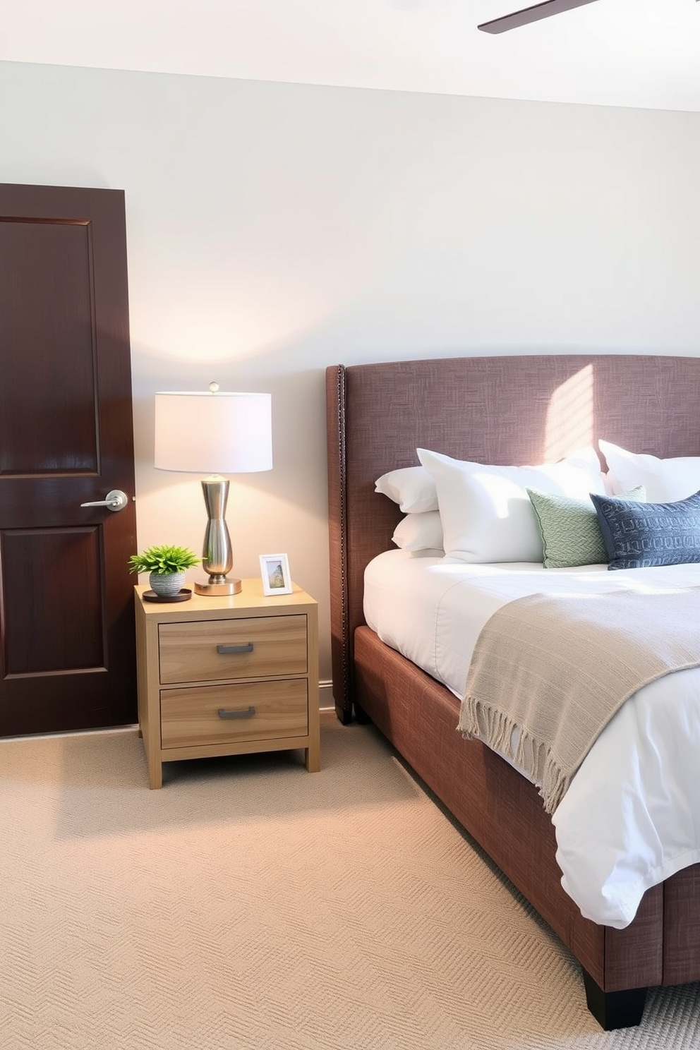 A cozy transitional bedroom features simple and functional bedside tables on either side of a plush upholstered bed. The tables are made of light wood with clean lines and include drawers for storage, topped with stylish lamps that provide warm lighting.