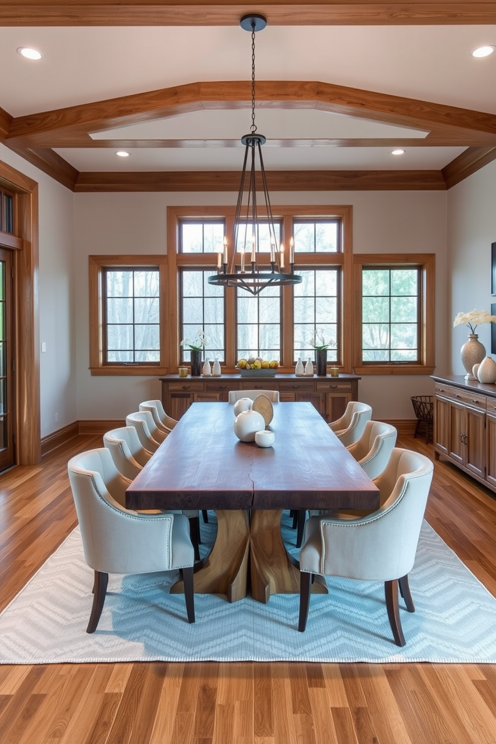 A transitional dining room featuring natural wood finishes that create a warm and inviting atmosphere. The table is a large reclaimed wood piece surrounded by upholstered chairs in neutral tones, complemented by a statement chandelier above. Soft lighting enhances the cozy ambiance, while large windows allow natural light to flood the space. A sideboard made of matching wood provides storage and display space for elegant dinnerware and decor.