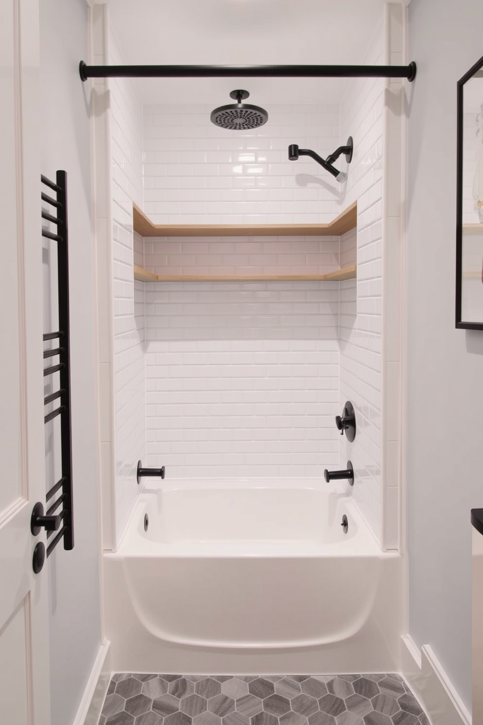 A compact tub shower combo is designed with sleek built-in shelves for optimal storage. The walls are tiled in a soft white, while the floor features a contemporary gray hexagon pattern.