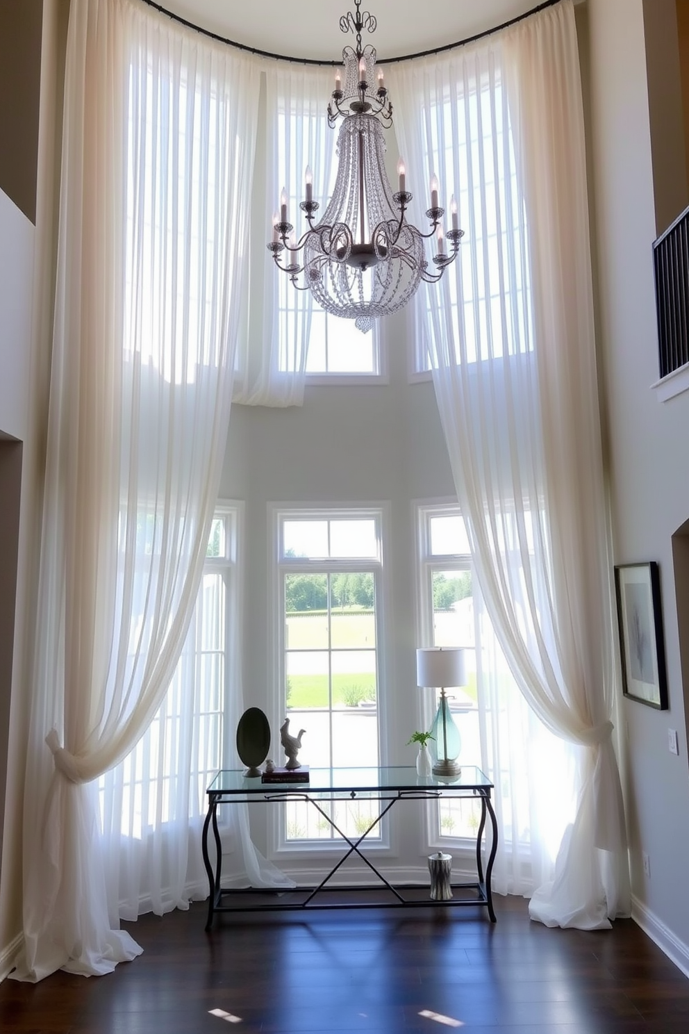 Window treatments to frame natural light. Elegant sheer curtains drape gracefully from a decorative rod, allowing sunlight to filter softly into the space. Two story foyer design ideas. A grand chandelier hangs from the high ceiling, illuminating the open area while a stylish console table sits against the wall, adorned with decorative accents.