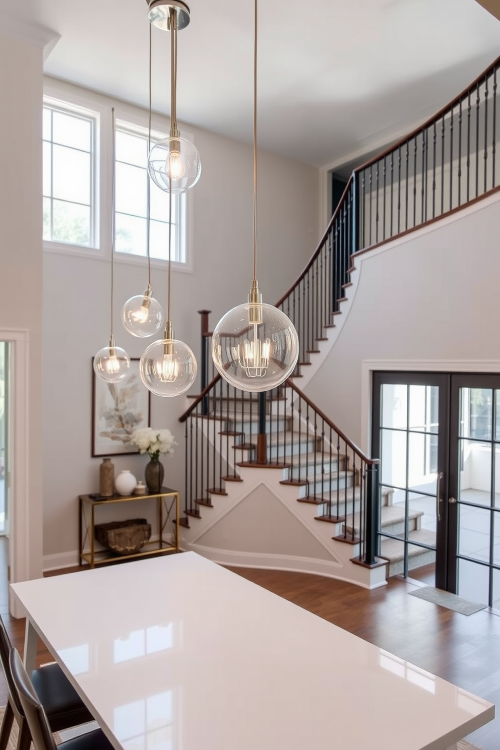 Unique pendant lights for modern touch. Sleek glass globes hang from a brushed nickel fixture, casting a warm glow over a minimalist dining table. The lights are arranged at varying heights to create visual interest and enhance the contemporary aesthetic. Two Story Foyer Design Ideas. A grand staircase with wrought iron railings curves elegantly, flanked by large windows that flood the space with natural light. The foyer features a statement chandelier that draws the eye upward, complemented by a console table adorned with decorative accents.