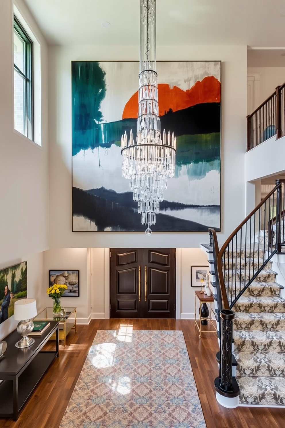 A stunning two-story foyer featuring decorative ledges for art display. The walls are painted in a soft beige, and the flooring is a polished dark hardwood that contrasts beautifully with the light colors. On the ledges, a curated selection of artwork and sculptures is showcased, creating an inviting atmosphere. A grand chandelier hangs from the ceiling, illuminating the space and highlighting the decorative elements.