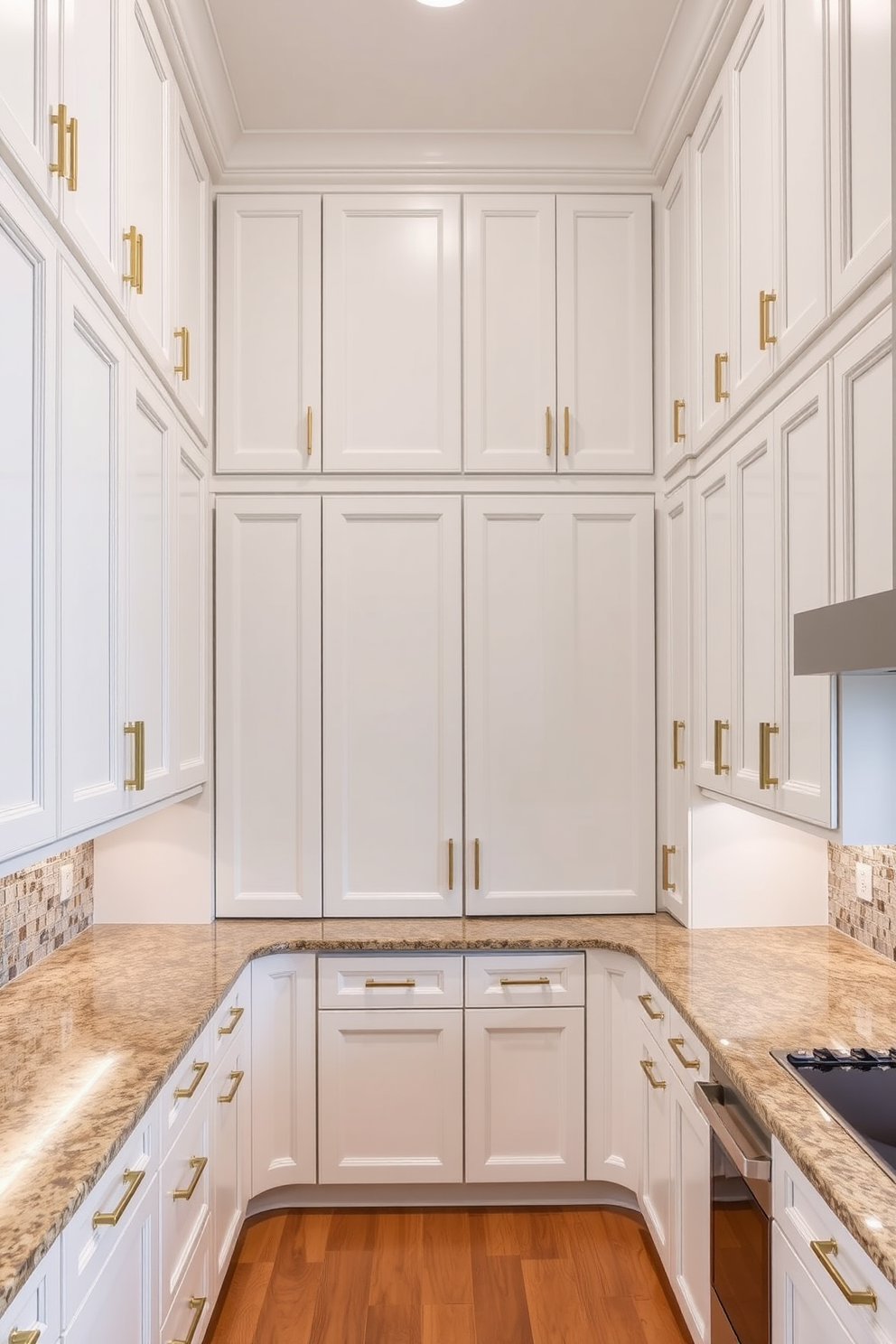 A U-shaped kitchen featuring tall cabinets that reach the ceiling for maximized storage. The cabinets are finished in a sleek white with gold hardware, and the countertops are a rich granite with subtle veining.