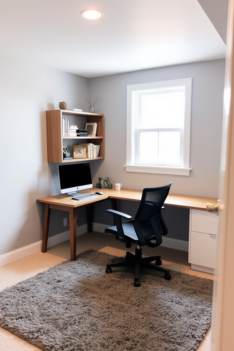 A cozy unfinished basement transformed into a functional workspace. The space features a sleek wooden desk paired with a comfortable ergonomic chair, positioned near a window for natural light. The walls are painted in a soft gray tone, creating a calming atmosphere. Shelves filled with books and decorative items line one side, while a plush area rug adds warmth underfoot.