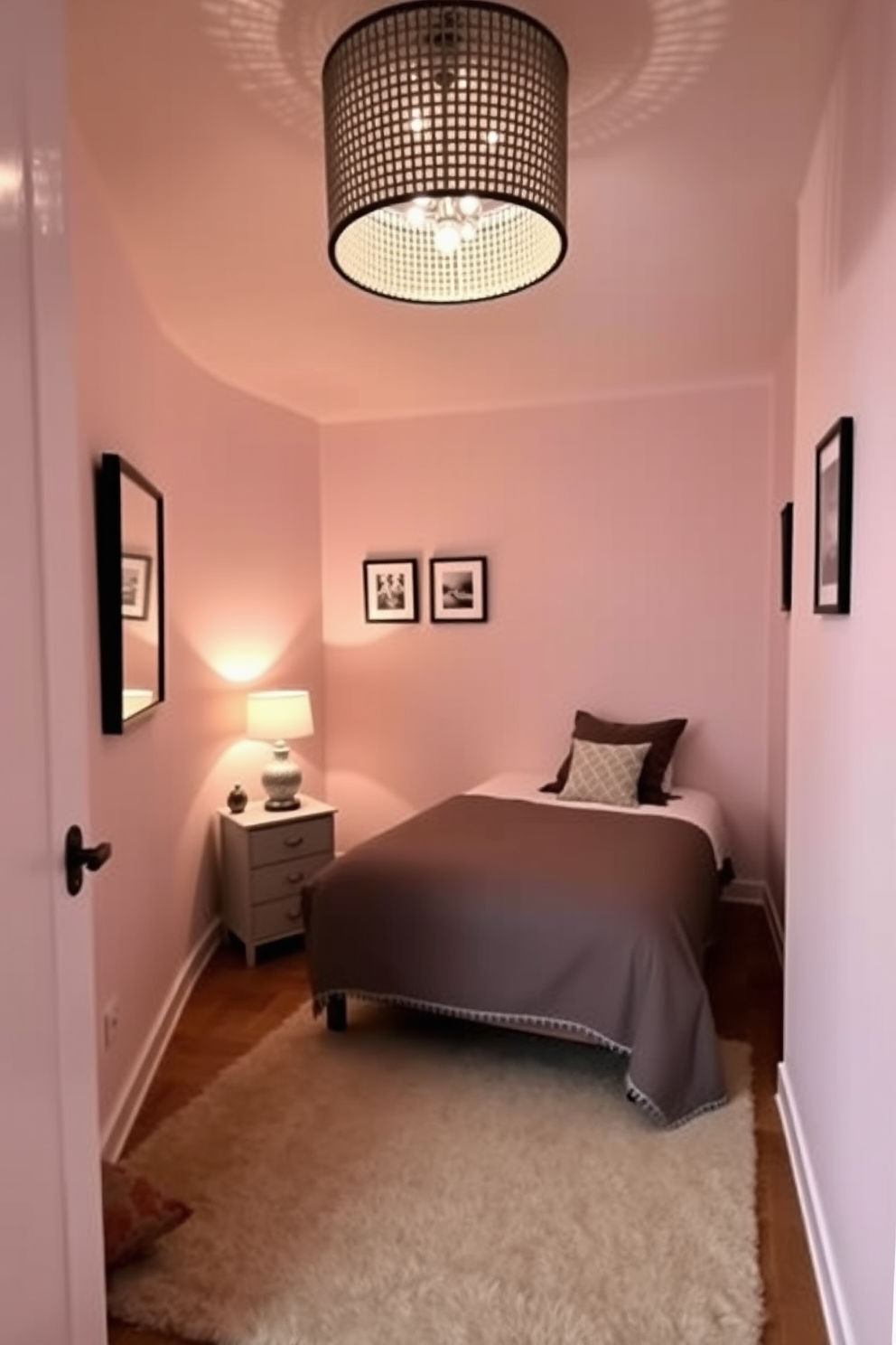 A cozy very small bedroom featuring a statement light fixture that draws attention to the ceiling. The walls are painted in a soft pastel hue, and the bed is positioned against one wall with decorative pillows adding a pop of color. In one corner, a compact nightstand holds a stylish lamp that complements the light fixture. A small rug lies under the bed, enhancing the warmth of the space while a few framed pictures adorn the walls.