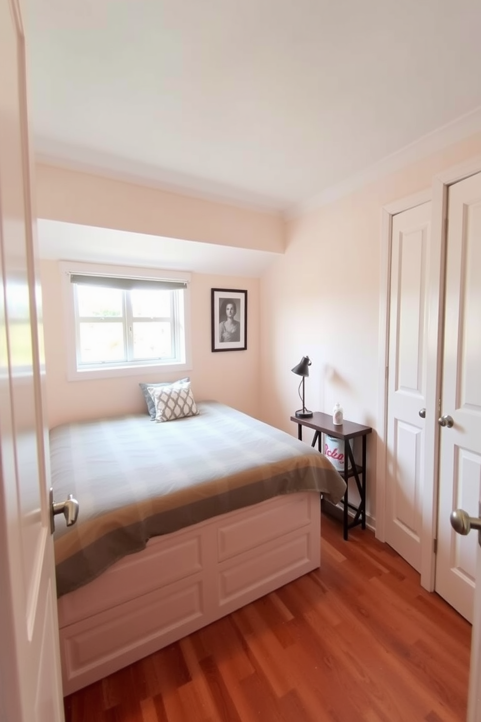 A cozy very small bedroom featuring a bed with built-in storage underneath. The walls are painted in a soft pastel color, and a small bedside table holds a stylish lamp.