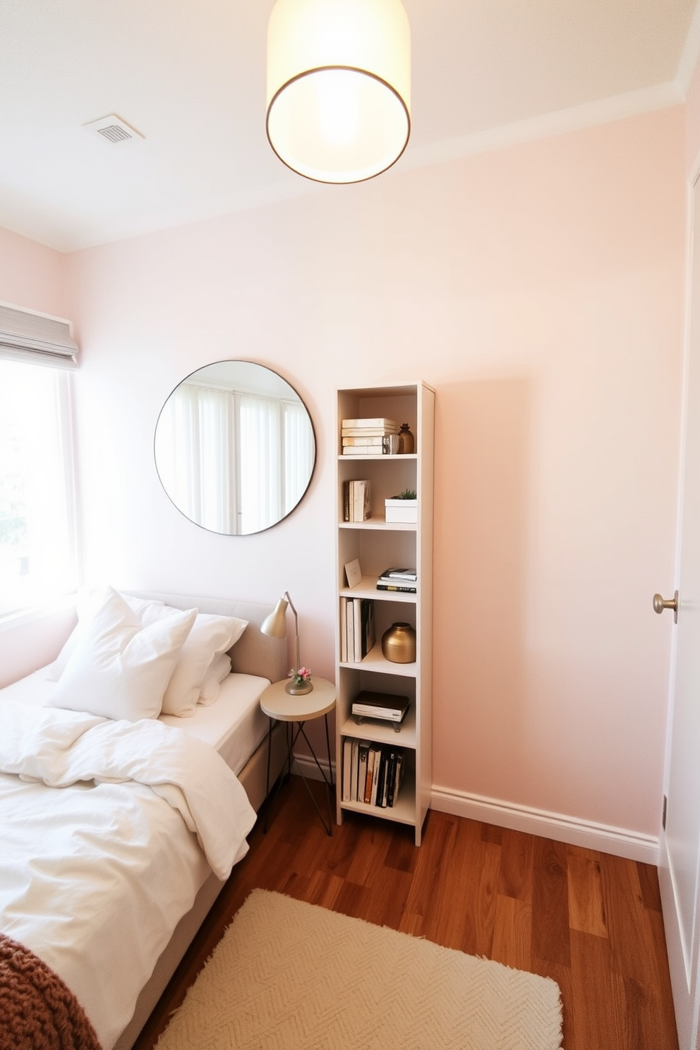 A cozy very small bedroom featuring a light-colored bed with plush bedding against a soft pastel wall. A large round mirror hangs above a compact bedside table, reflecting natural light from a nearby window. In the corner, a tall, narrow bookshelf holds a few decorative items and books, maximizing vertical space. Soft lighting from a stylish pendant lamp adds warmth, creating an inviting atmosphere.