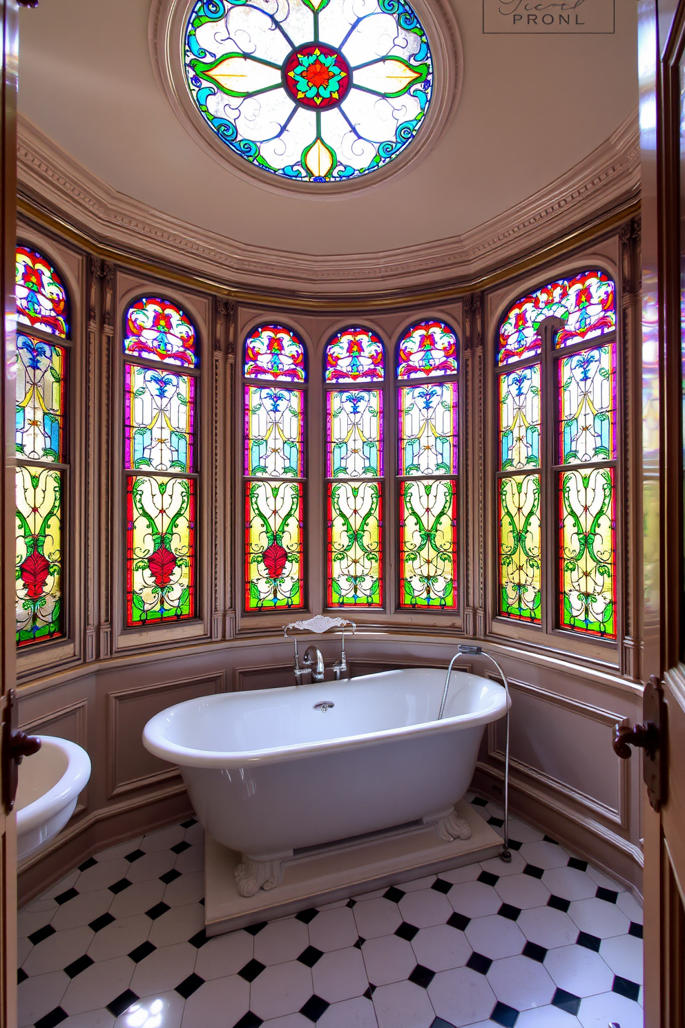 A Victorian bathroom featuring open shelving that elegantly displays a collection of vintage toiletries and decorative items. The shelves are made of dark wood, intricately carved, and positioned above a classic clawfoot bathtub, creating a charming focal point in the space.