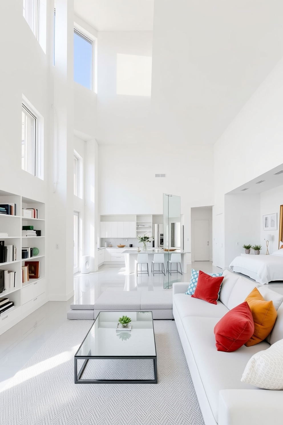 A spacious white apartment featuring high ceilings and large windows that allow natural light to flood the space. The walls are painted in a crisp white, enhancing the sense of openness and airiness throughout the living area. The living room includes a comfortable sectional sofa adorned with colorful cushions, paired with a sleek coffee table made of glass and metal. A minimalist bookshelf filled with curated decor items adds personality to the room without overwhelming the design. In the kitchen, white cabinetry complements the marble countertops, creating a seamless and modern look. An island with bar stools provides additional seating and serves as a functional space for cooking and entertaining. The bedroom is designed with a plush white bed dressed in soft linens, creating a serene retreat. Large mirrors reflect light and make the space feel larger, while subtle greenery adds a touch of warmth and life.