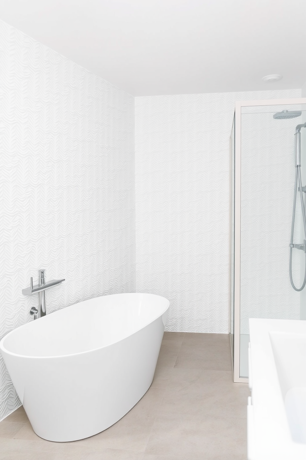 Textured white wallpaper adds subtle depth to the space, creating an elegant backdrop for a serene atmosphere. The bathroom features sleek white fixtures, including a freestanding tub and a modern shower, enhancing the overall minimalist aesthetic.