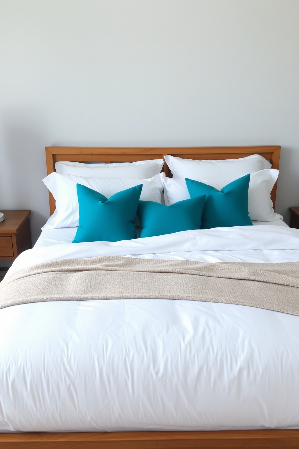 A serene white bedroom featuring a plush white bedding set adorned with pastel accent pillows in soft shades of pink and blue. The walls are painted in a light, airy hue, and large windows allow natural light to fill the space, creating a tranquil atmosphere.