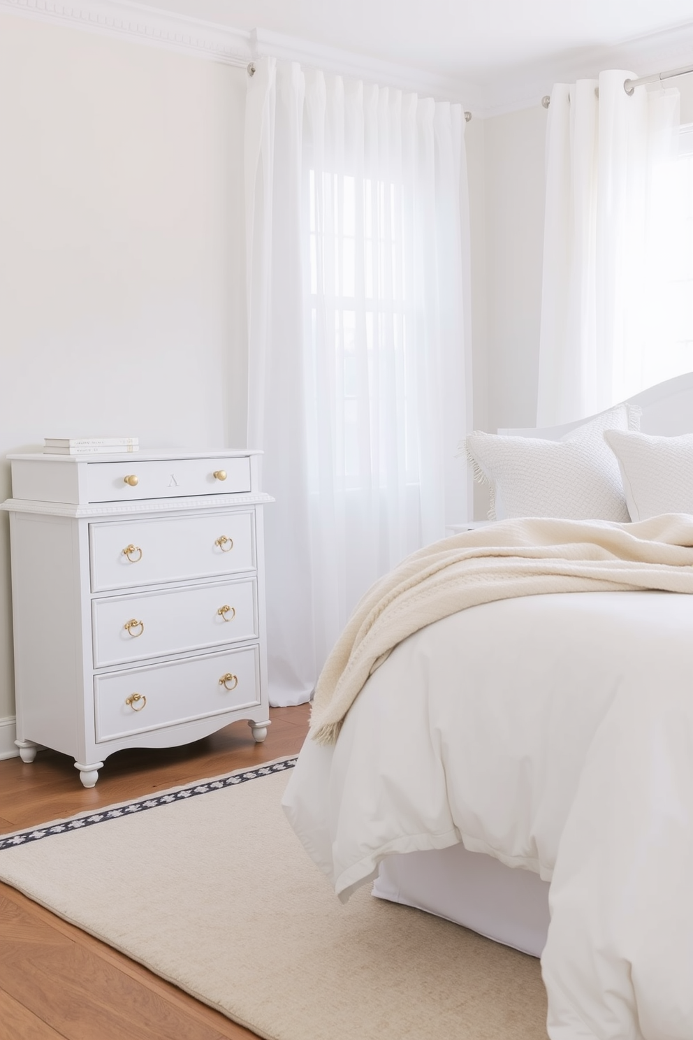 A chic white dresser with elegant gold hardware stands against a soft pastel wall. The room features a plush white bed adorned with textured pillows and a cozy throw blanket, creating a serene and inviting atmosphere. Natural light floods the space through sheer curtains, enhancing the airy feel of the white bedroom. A stylish area rug lies underfoot, adding warmth and comfort to the minimalist design.