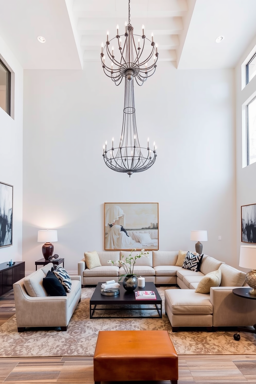 High ceilings create an airy and spacious atmosphere in the family room, enhanced by large statement pieces that draw the eye. A plush sectional sofa in a neutral tone is complemented by oversized art pieces and a striking chandelier that adds elegance to the space.