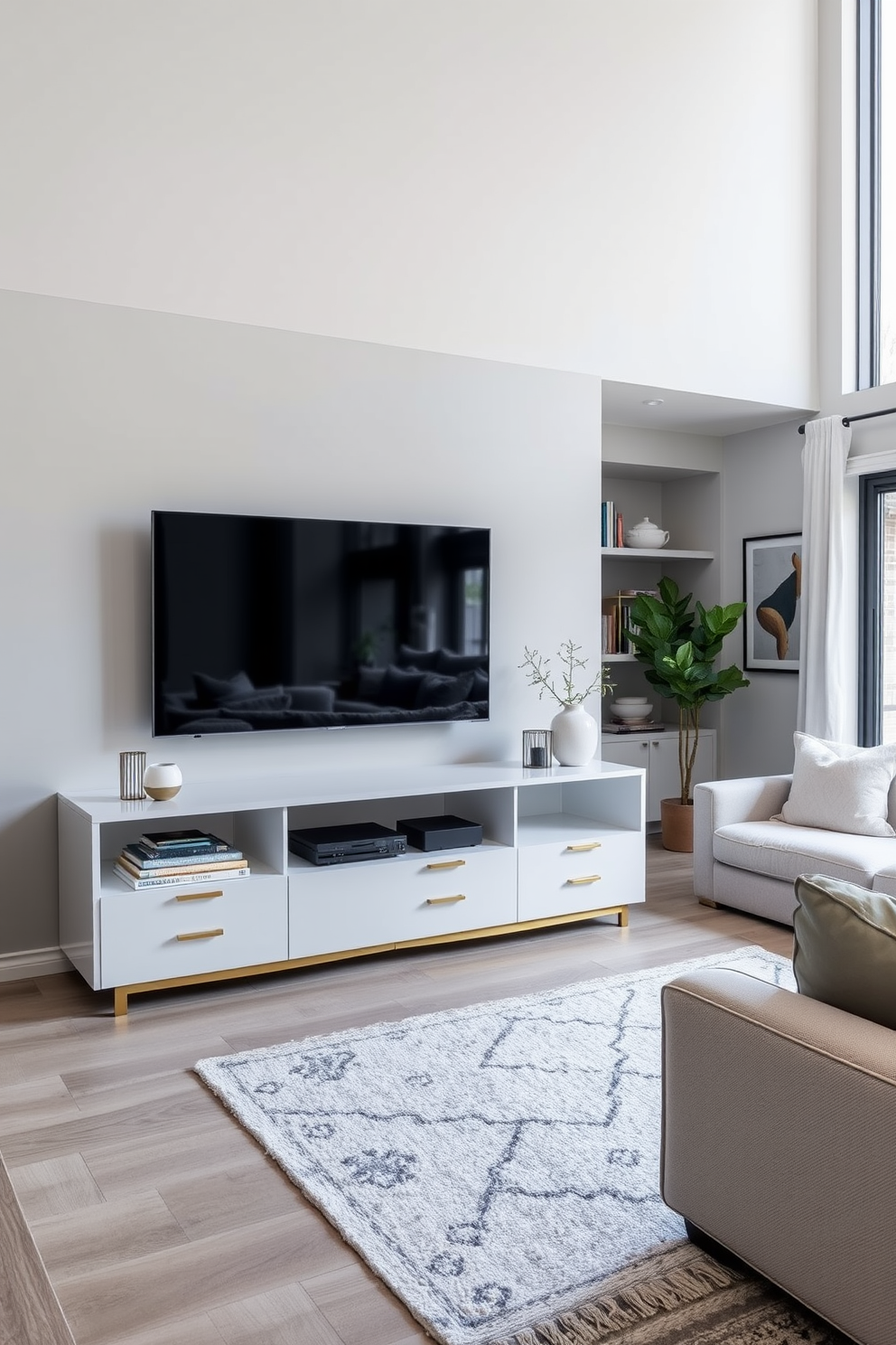 A sleek media console is centered against a soft gray wall, featuring clean lines and a high-gloss finish. The console is equipped with ample storage space for electronics, books, and decorative items, complemented by stylish brass hardware. The family room is designed with a cozy yet modern aesthetic, featuring a large sectional sofa in a light fabric and a plush area rug. Large windows allow natural light to flood the space, enhancing the airy feel and showcasing curated artwork on the walls.