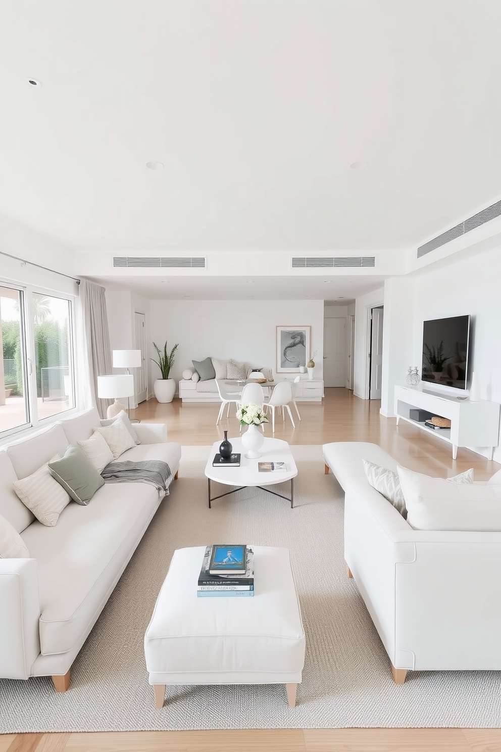 A spacious family room featuring minimalist furniture with clean lines. The color palette consists of soft whites and light grays, creating a serene atmosphere.