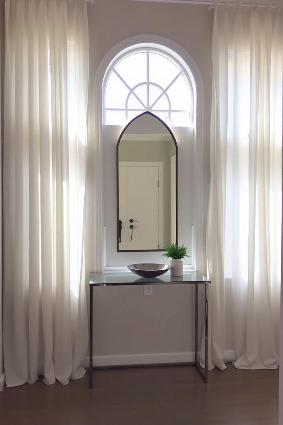 Soft white curtains gently frame the windows, allowing natural light to flood the space. The curtains create a serene atmosphere, enhancing the brightness of the foyer. The foyer features a sleek console table with a minimalist design, adorned with a decorative bowl and a small potted plant. A statement mirror above the table reflects the light and adds depth to the entryway.