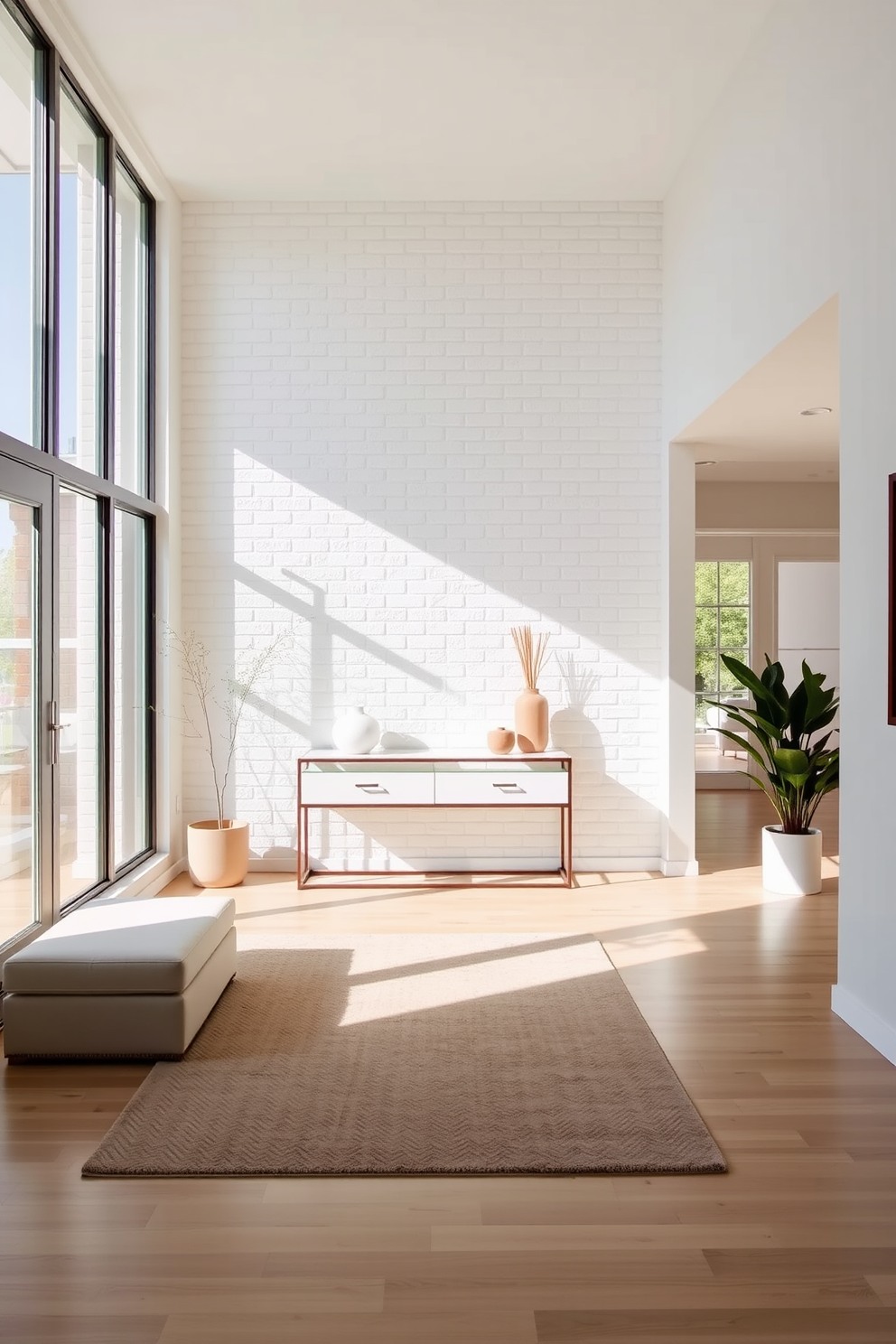 A bright and airy foyer features a stunning white brick feature wall that adds character and texture to the space. The floor is adorned with a light wood finish, complementing the clean lines of the minimalist furniture. Natural light floods the area through large windows, illuminating a sleek console table topped with decorative accents. A soft area rug in neutral tones anchors the space, creating a warm and inviting atmosphere.