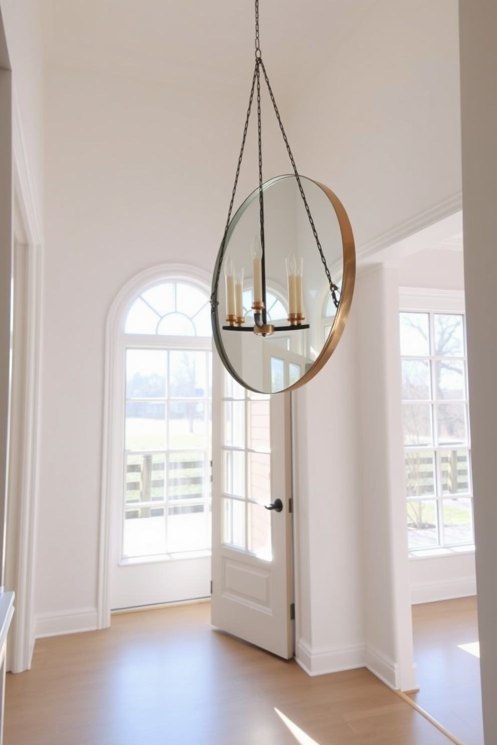 A bright and airy foyer adorned with white wainscoting that adds a touch of classic charm. The space features a large round mirror above a sleek console table, complemented by a stylish pendant light hanging from the ceiling. The floor is covered with a light gray runner rug that contrasts beautifully with the white wainscoting. Potted greenery adds a refreshing touch, bringing life to the entryway while maintaining an elegant atmosphere.