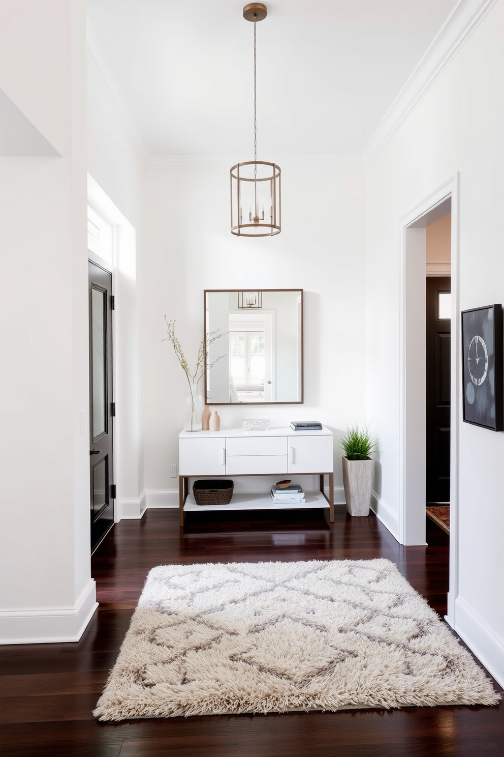 A bright and airy foyer features a large round mirror that reflects natural light, creating an inviting atmosphere. The walls are painted in a soft white hue, complemented by elegant wainscoting that adds a touch of sophistication. A sleek console table sits beneath the mirror, adorned with a stylish lamp and a few curated decorative items. The flooring consists of light hardwood, providing warmth and contrast to the overall design.