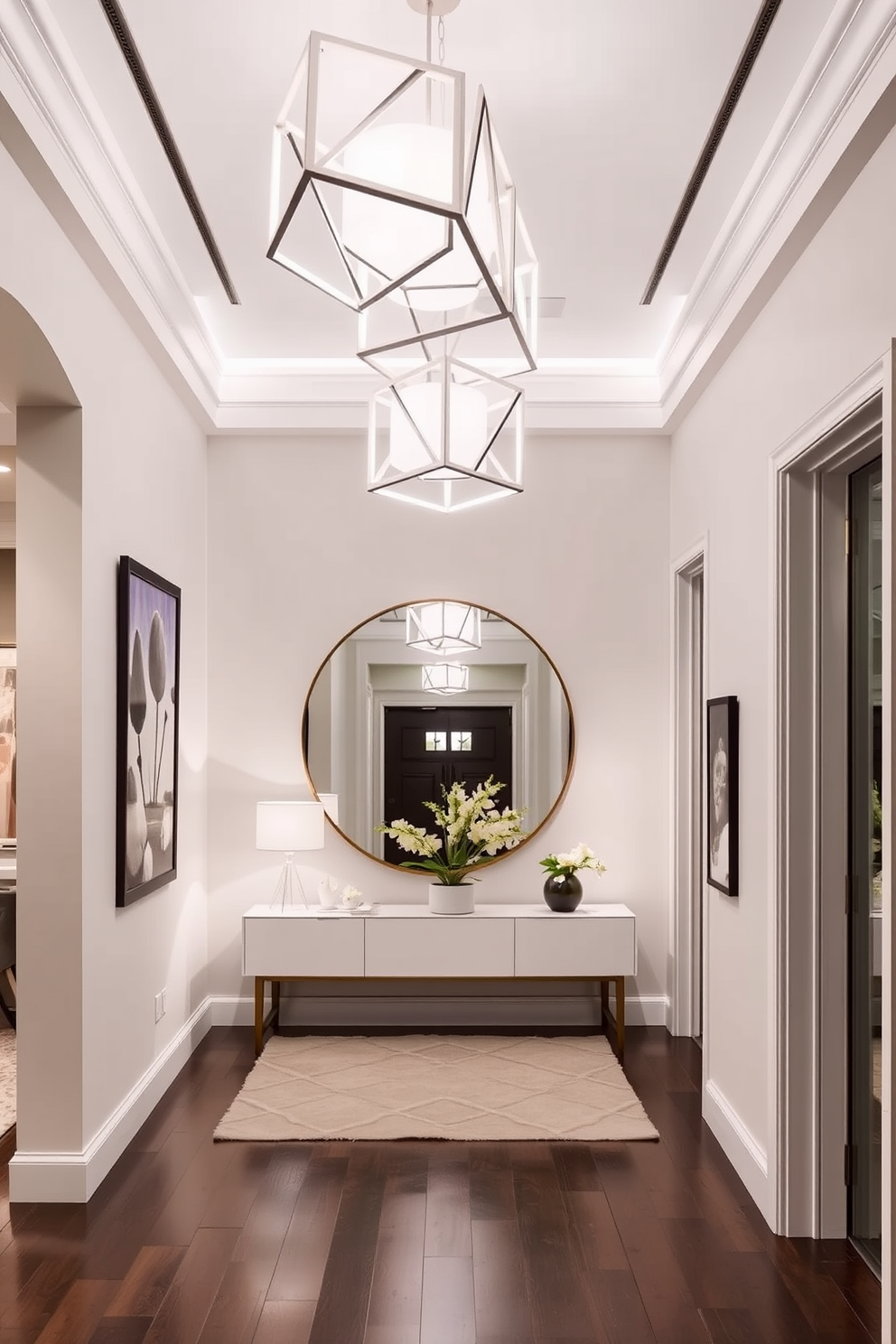 A stylish foyer featuring geometric white light fixtures that provide a modern touch. The space is adorned with a sleek console table and a large round mirror reflecting the elegant lighting.