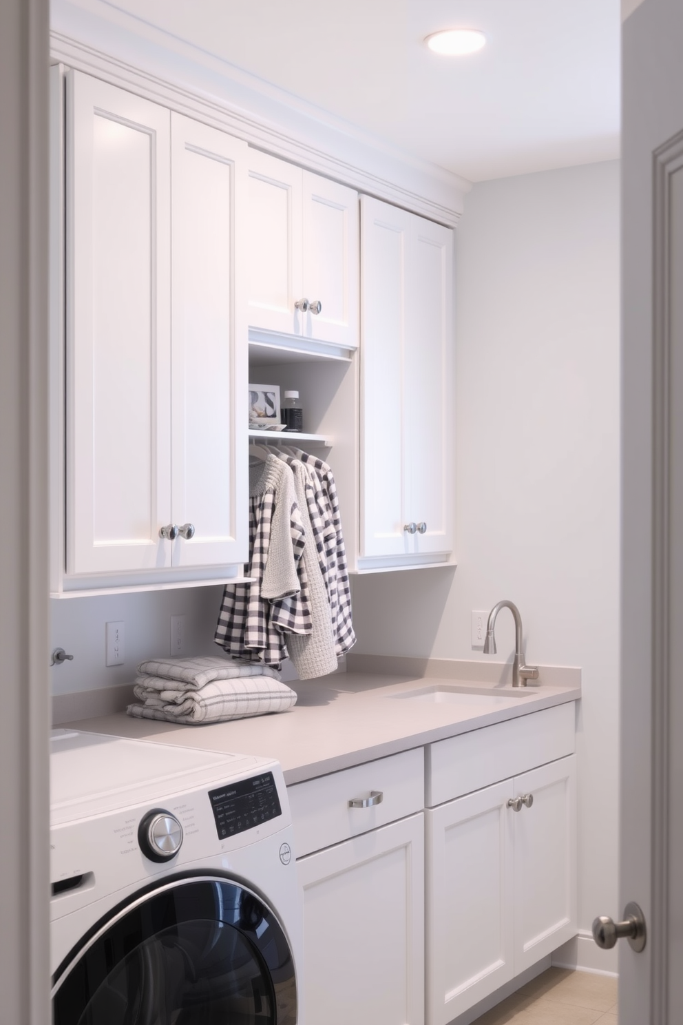 A functional mudroom laundry combo space features a spacious layout with built-in cabinetry for storage. The walls are painted a crisp white, complemented by a durable gray tile floor that withstands heavy use. A large farmhouse sink is installed for convenience, with a stylish faucet above it. Shelves above the sink hold neatly folded towels and laundry essentials, while a bench provides a comfortable spot to sit and remove shoes.