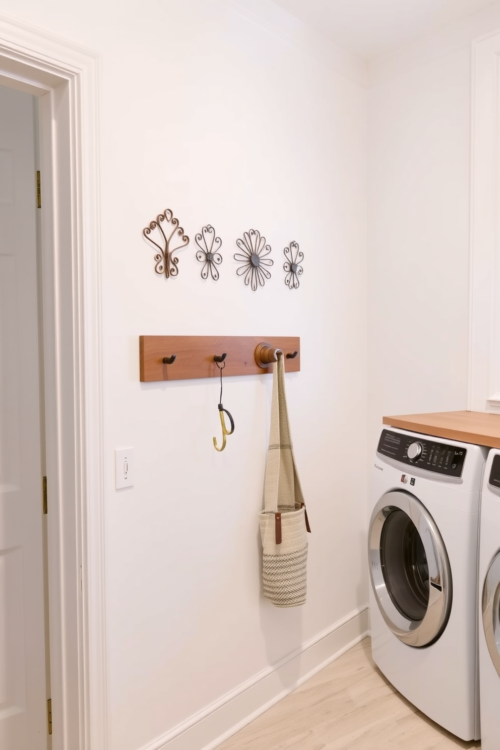 A bright and airy laundry room features decorative hooks mounted on the wall for easy access to frequently used items. The walls are painted in a soft white hue, and the space is accented with natural wood elements for a warm and inviting feel.